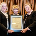 FSoS Alum Sharon Augenstein (center) is presented with her Distinguished Alumni Award by CEHD Dean Jean Quam (right) and Chief Development Officer Susan Holter.