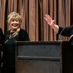 CEHD Dean Jean Quam shares a humorous ancedote while presenting Distinguished Alumni honors to FSoS Alum Sharon Augenstein (center). Chief Development Officer Susan Holter assists with the presentation.