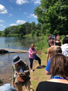 Photo of Summer Institute attendees on the shore of a lake