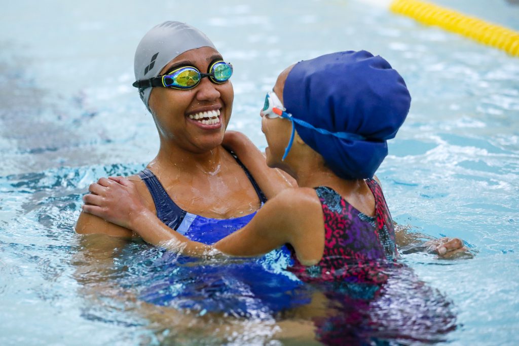 Ayanna laughing in the pool with her daughter